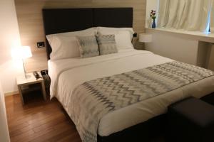 Postel nebo postele na pokoji v ubytování Hotel Nuvola