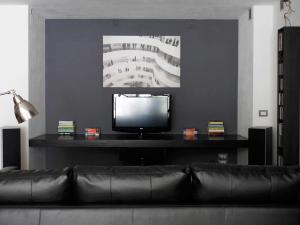 マルティナ・フランカにあるModern house in Valle d'Itriaのリビングルーム(黒いソファ、薄型テレビ付)