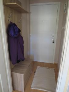 a room with a closet with a box and a door at Holiday Lux Apartment in Soko Banja