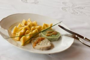 a plate of food with pasta and vegetables on a table at Gostilna Metka in Črni Vrh