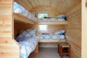 A bed or beds in a room at Coach Field Camp