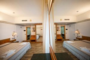Postel nebo postele na pokoji v ubytování Hotel Marina Bay