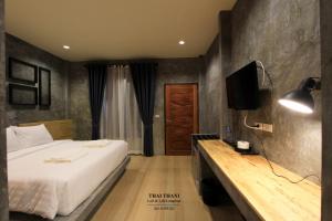 a bedroom with a bed and a television in it at THAI THANI Loft & Life Lamphun in Lamphun