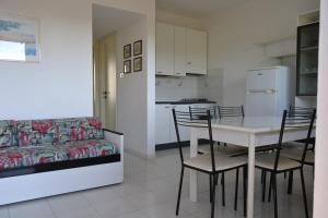 a living room with a table and chairs and a couch at Roberta Apartment in Marcelli
