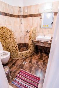 a bathroom with a sink and a toilet at Katefiani Villas in Perissa