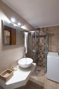 a bathroom with a sink and a shower at Castello Domus in Panormos Rethymno