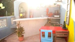 a patio with a counter and a table and a window at Casa De Piedra, Centro Histórico in Mérida