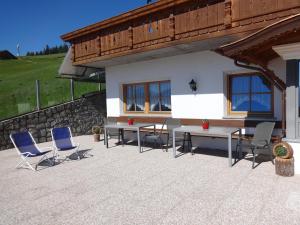 a patio with chairs and tables and a building at SCHUPFE- direkt neben der Kabinenbahn Gitschberg Jochtal in Maranza +63 photos