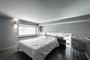 a bedroom with a large bed and a window at Grey Loft in Polignano a Mare