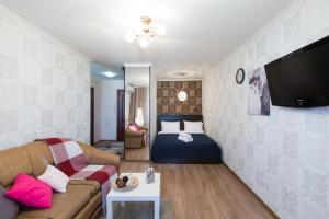 モスクワにあるLux Apartment Uralskayaのリビングルーム(ソファ、ベッド付)