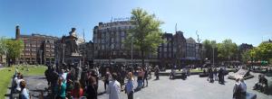 a crowd of people standing around in a city at Rembrandt Square Hotel in Amsterdam