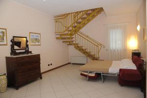 a bedroom with a staircase and a bed and a television at Hotel Plazza in Porcari