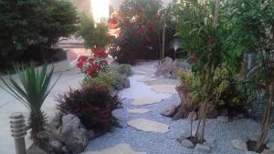 a garden with rocks and plants and flowers at Jasmina in Senj