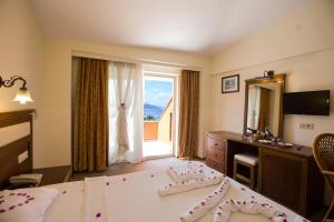 a bedroom with a bed and a large window at Valeri Beach Hotel in Kemer