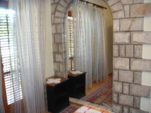 a living room with a stone wall and a mirror at Apartments Grispolis in Tivat +74 photos