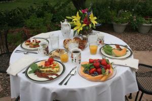 a white table with plates of food on it at Mon Ami Bed and Breakfast in Tucson