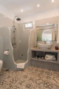 a bathroom with a sink and a mirror at Psilandis Studios in Adamantas