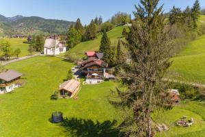 an aerial view of a house on a green hill at Haus Bergheimat in Oberstdorf