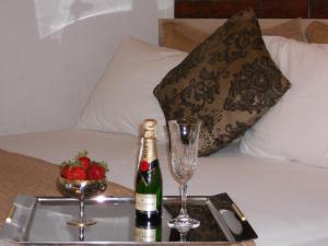 a tray with a bottle of champagne and glasses on a bed at Apartment Djukovic in Petrovac na Moru