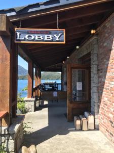 a building with a sign for a lodge at The Inn at Tough City in Tofino