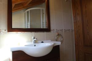 a white sink in a bathroom with a mirror at Apartamentos Casa Cerolleiro in Castropol +110 photos