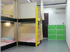 a bunk bed room with two bunk beds and a ladder at Dream Guesthouse in Seoul