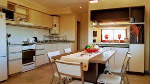 a kitchen with a table with a bowl of fruit on it at Edificio NIZA I in Villa Carlos Paz