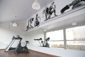 a gym with two treadmills and two exercise bikes at Big Executive Hotel in Araguari