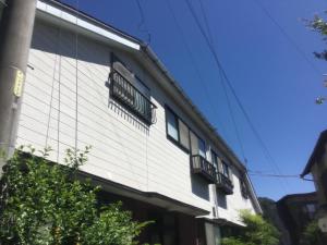a building with balconies on the side of it at Ryokan Sarashinaya in Kiso