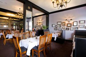a dining room with tables and chairs and a chandelier at Katoomba Hotel in Katoomba