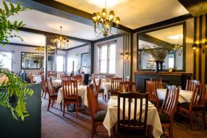 a dining room with tables and chairs and mirrors at Katoomba Hotel in Katoomba +7 photos