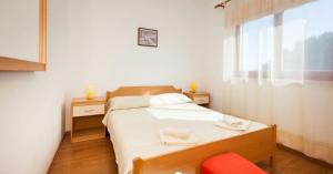 Postel nebo postele na pokoji v ubytování Apartments Hrvatin