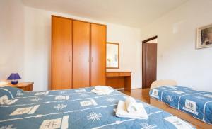 Postel nebo postele na pokoji v ubytování Apartments Hrvatin