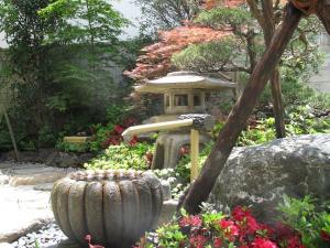 a garden with a pagoda and a garden with flowers at Ryokan Fuji in Tokyo