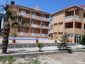 a large apartment building with a pool in front of it at Guesthouse Natali in Gonio