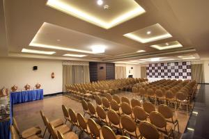 a room with rows of chairs and a stage in it at Hotel Hyderabad Grand in Shamshabad