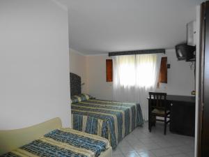 Postel nebo postele na pokoji v ubytování Hotel Borgo Antico