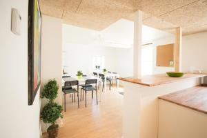 a kitchen and dining room with a table and chairs at Idestrup Bed and Breakfast in Idestrup