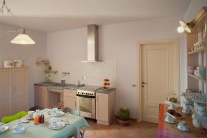 a kitchen with a table and a stove and a table and a tableablish at Il Germano Reale in Alba