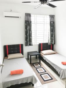 a room with two beds and a window at Palm Homestay Dwiputra Putrajaya in Putrajaya