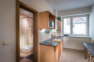 a small kitchen with a sink and a shower at ALMET apartmánové štúdio 206 in Donovaly +34 photos