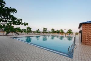 a large swimming pool in a brick building at GP Hotels and Resorts in Nashik