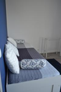 two pillows on a bed in a room at Apartamenty Willa Nawigator in Gdynia