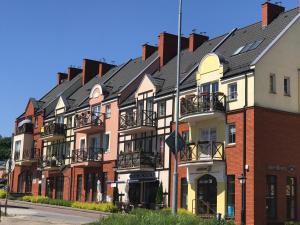 a row of houses on the side of a street at Apartament White in Śrem +21 photos