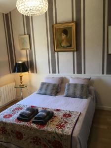 a bedroom with a bed with pillows on it at Maison au pied des ocres in Roussillon