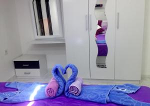 a room with two swans laying on a bed at Apartment Decumana in Krk +79 photos