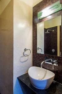 a bathroom with a sink and a mirror at Hotel Metropolitan in Jaipur