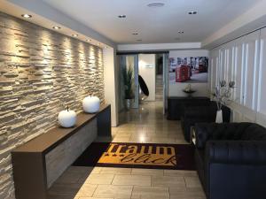 a living room with a stone wall and a lobby at Hotel Traumblick in Cochem