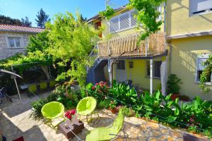 a garden in front of a house with plants at Apartments Veky 3 in Split