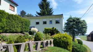 ein Haus mit einem Zaun davor in der Unterkunft Ferienwohnung "Am Weinberg" in Bad Schmiedeberg